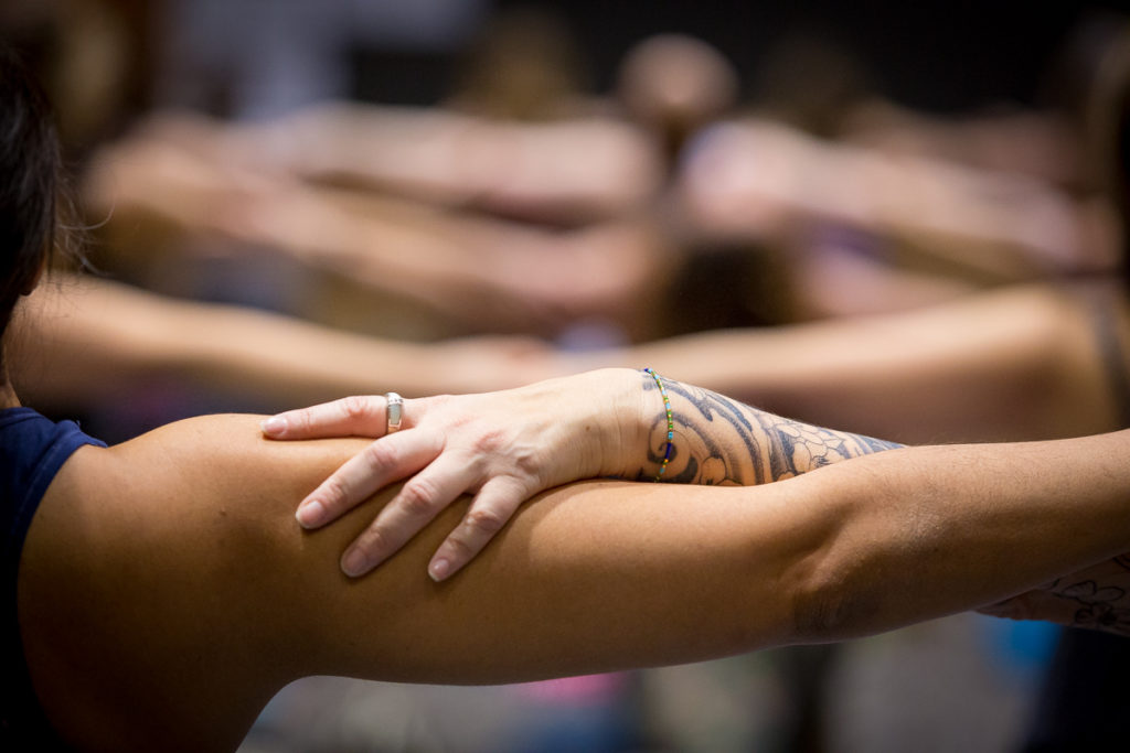 a community of yogis practicing together at northwest yoga conference